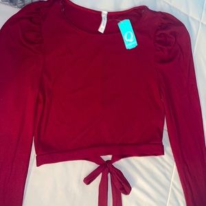 a red top from with ruffle long sleeve’s